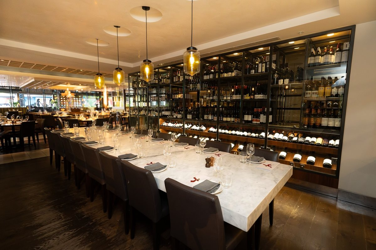 Wine cabinets and a table arranged for a gathering